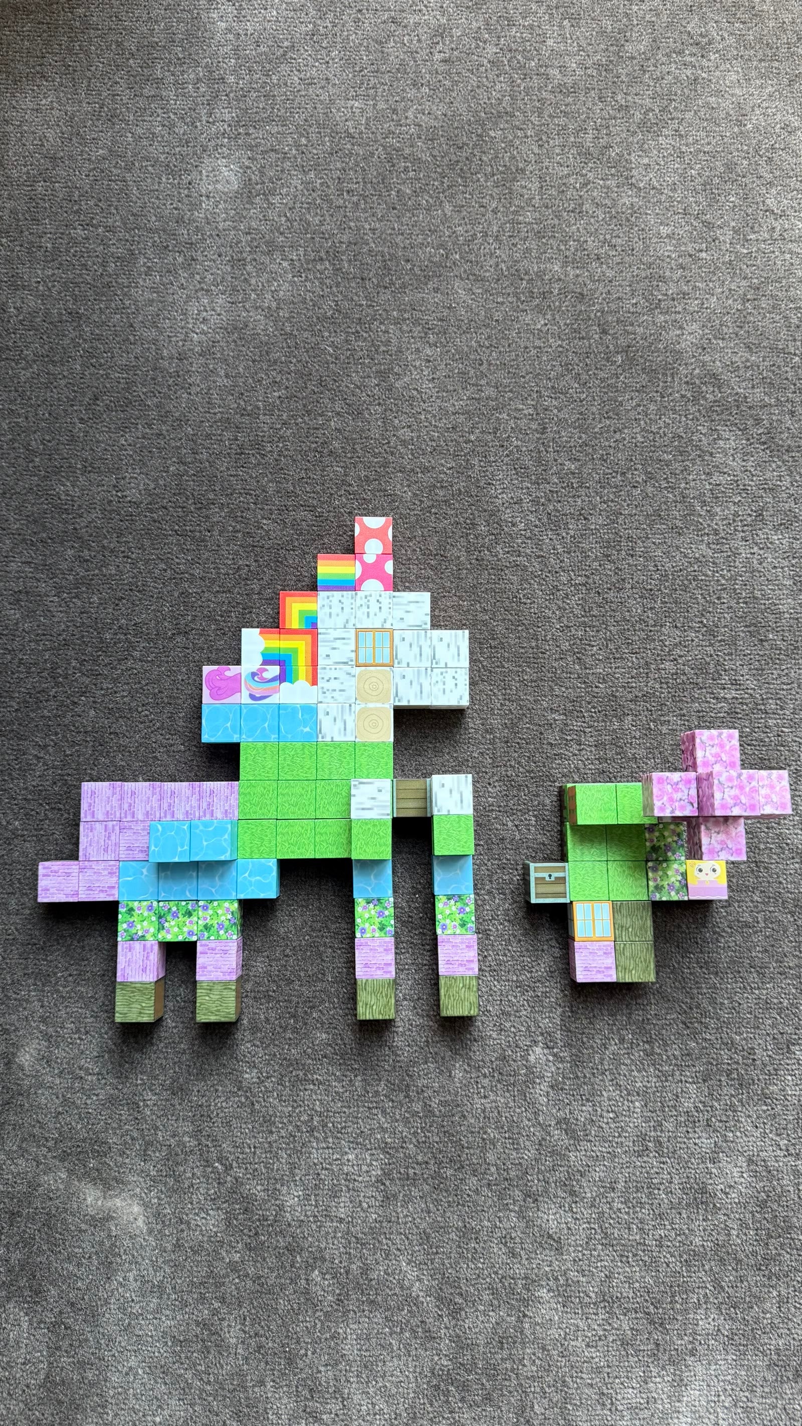 Real photo of unicorn and companion shapes built from MillieFun magnetic cubes with instruction sheet
